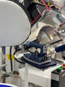 A finished garment leaving the shop, sealed in a presentation bag